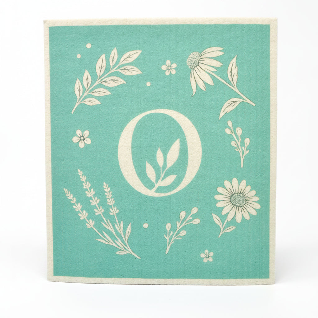 Om Naturale reusable compostable Eco Cloth made from cellulose and cotton with botanical print on a teal background.