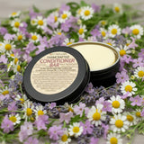 Farmcrafted solid conditioner bar in reusable black tin, surrounded by real chamomile and Okanagan lavender – 65 g bar replaces 3 plastic bottles, handmade in Armstrong, BC