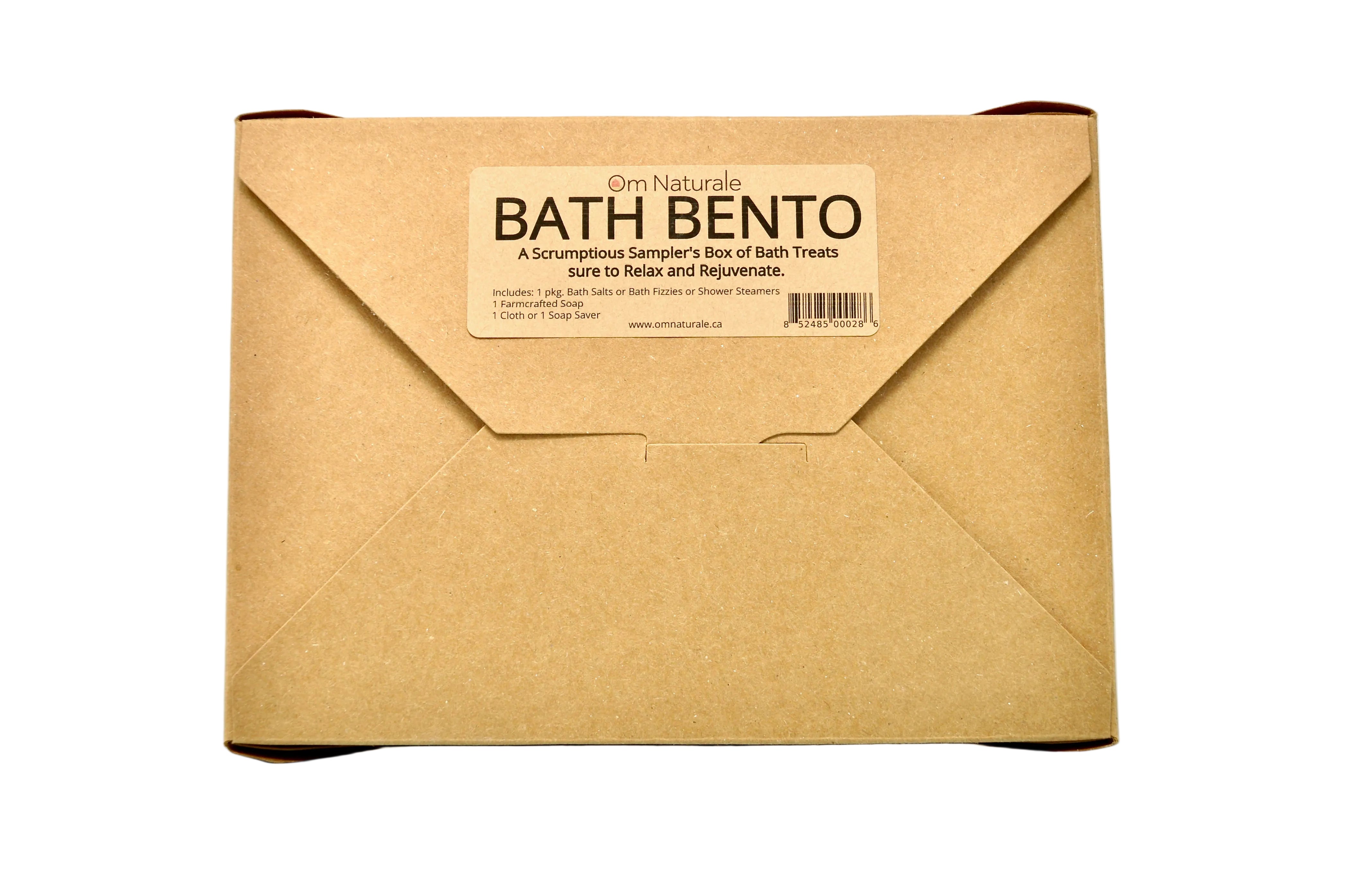 Open Om Naturale Bath Bento Box revealing handmade soap, bath salts or steamers, reusable organic cotton cloth, all in compostable eco packaging