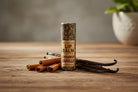 Cinnamon Vanilla Compostable Lip Balm by Om Naturale displayed in a lifestyle setting, natural balm in compostable tube for soft, hydrated lips