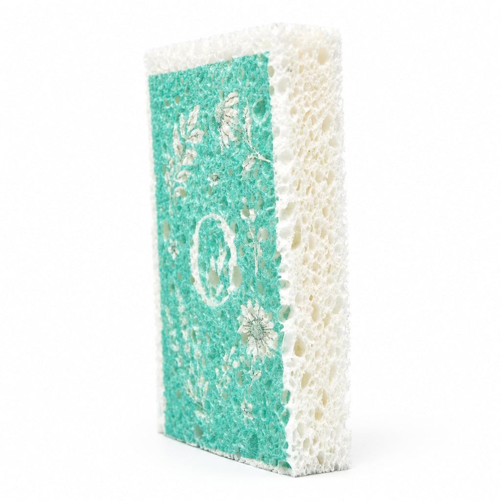 Om Naturale rectangular eco cleaning sponge with a teal background and white floral design