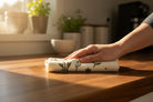 Reusable Eco Cloth wiping a kitchen countertop as an alternative to paper towels.