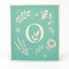 Om Naturale reusable compostable Eco Cloth made from cellulose and cotton with botanical print on a teal background.