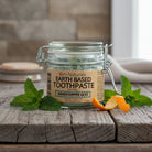 Grasshopper Goo natural toothpaste with calendula flowers – fluoride-free SLS-free glycerin-free formula, chlorophyll-infused with organic coconut oil and xylitol, whimsical herbal care handmade by Om Naturale BC.