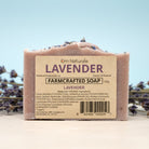 Handmade lavender farmcrafted soap displayed with fresh lavender bouquet – organic, palm oil free bar with soothing oatmeal and relaxing essential oil scent, by Om Naturale in Armstrong BC