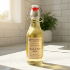 Om Naturale Lemony Lemongrass Hand & Body Wash displayed in a bright, sunlit bathroom with natural décor.