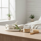 Om Naturale Natural Dry Shampoo displayed on a wooden vanity with natural hair care essentials in soft morning light.
