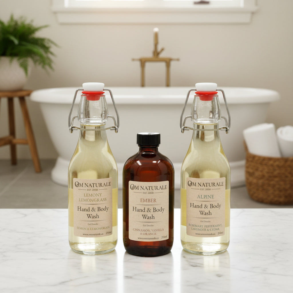 Collection of Om Naturale Hand & Body Wash in Ember, Alpine and Lemony Lemongrass displayed on a stylish bathroom vanity.