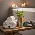 Om Naturale Peppermint Plantain Foot Balm displayed on a wooden bench with towels and botanical décor in a relaxing foot care setting.