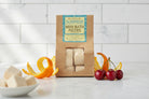 Om Naturale Surprise Mini Fizzies in bathtub setting, plant-based bath fizzies with natural botanicals and essential oils for soothing and playful bath experience