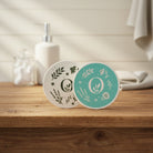 Teal and White Round Eco Sponges on a bathroom vanity.