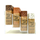 Om Naturale Tinted Lip Balm Starter Set, four natural clay-coloured lip balms in compostable tubes arranged in a display tray — Autumn, Snow, Dusty Rose, Lavender