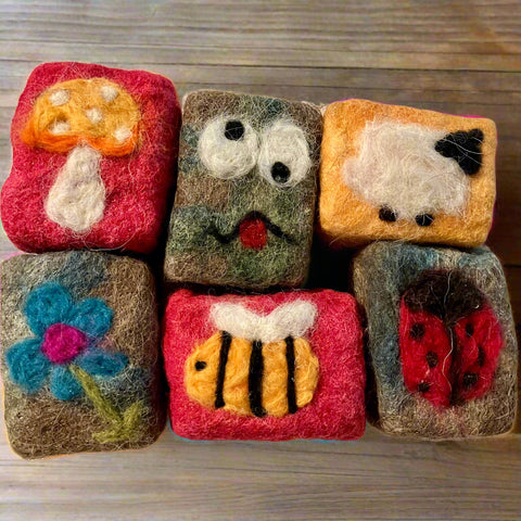 Handmade vegan wool felted soaps with bee, face, mushroom, flower, and ladybug patterns, crafted in Okanagan, BC