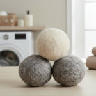 Set of three natural wool dryer balls for eco-friendly laundry, reusable plastic-free alternative to dryer sheets that helps soften clothes and reduce drying time